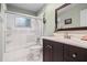 Bright bathroom featuring shower over tub, vanity with dark wood cabinets and neutral countertop at 427 N Lakeview Ave, Winter Garden, FL 34787