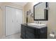 Bathroom featuring a decorative mirror, vanity, textured wallpaper and closet at 427 N Lakeview Ave, Winter Garden, FL 34787
