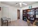 Well-lit bedroom featuring plush carpets, ceiling fan, and built-in bookcase at 427 N Lakeview Ave, Winter Garden, FL 34787