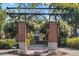 Decorative Centennial Plaza entrance with brick columns, floral accents, and a central fountain at 427 N Lakeview Ave, Winter Garden, FL 34787