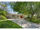 Charming single-story home with a well-manicured lawn, a spacious driveway, and a welcoming red front door at 427 N Lakeview Ave, Winter Garden, FL 34787