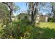 Side view of a single-Gathering home with a lush yard and mature trees at 427 N Lakeview Ave, Winter Garden, FL 34787