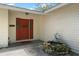 Charming home featuring a covered entrance with a wreath on the red front door and stone water feature at 427 N Lakeview Ave, Winter Garden, FL 34787