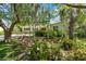 Landscaped front yard with flowering shrubs and mature trees giving a serene view of the home at 427 N Lakeview Ave, Winter Garden, FL 34787