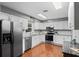 Modern kitchen featuring stainless steel appliances, bright white cabinetry, and granite counters at 427 N Lakeview Ave, Winter Garden, FL 34787