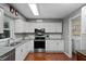 Updated kitchen with stainless appliances, granite countertops, and a view into the laundry room at 427 N Lakeview Ave, Winter Garden, FL 34787