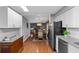 Bright kitchen with modern appliances and hardwood floors leading to a dining area at 427 N Lakeview Ave, Winter Garden, FL 34787