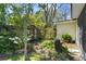 Lush garden with blooming flowers, mature trees, and privacy fence provides a tranquil outdoor space at 427 N Lakeview Ave, Winter Garden, FL 34787