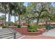 Beautiful landscaping featuring a brick retaining wall with planters and a striking dragonfly statue in a park-like setting at 427 N Lakeview Ave, Winter Garden, FL 34787
