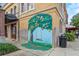 Charming orange tree mural with a swing, painted on the side of a historic building near public parking at 427 N Lakeview Ave, Winter Garden, FL 34787
