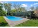 Sparkling private pool with a tranquil backyard view and lounge area at 427 N Lakeview Ave, Winter Garden, FL 34787