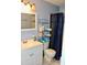 Bathroom featuring a vanity with sink, a toilet with storage, and a shower with a blue curtain at 429 Sheoah Blvd # 8, Winter Springs, FL 32708
