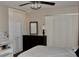 Cozy bedroom featuring a ceiling fan, dresser with mirror, and white closet doors at 429 Sheoah Blvd # 8, Winter Springs, FL 32708
