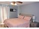 Spacious bedroom with a comfortable bed, nightstands, ceiling fan, and natural light at 429 Sheoah Blvd # 8, Winter Springs, FL 32708