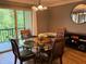 Dining room features a glass table, seating for four, and view of the outdoor balcony at 429 Sheoah Blvd # 8, Winter Springs, FL 32708