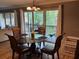 Dining room features a glass table, seating for four, and view of the outdoor balcony at 429 Sheoah Blvd # 8, Winter Springs, FL 32708