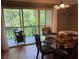Dining room features a glass table, seating for four, and view of the outdoor balcony at 429 Sheoah Blvd # 8, Winter Springs, FL 32708