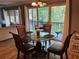 Dining room features a glass table, seating for four, and view of the outdoor balcony at 429 Sheoah Blvd # 8, Winter Springs, FL 32708
