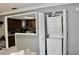 Functional laundry area with stacked washer and dryer adjacent to the charming kitchen area at 429 Sheoah Blvd # 8, Winter Springs, FL 32708