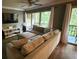 Comfortable living room features a plush sectional sofa, entertainment center, and sliding glass doors to balcony at 429 Sheoah Blvd # 8, Winter Springs, FL 32708