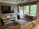 Comfortable living room features a plush sectional sofa, entertainment center, and sliding glass doors to balcony at 429 Sheoah Blvd # 8, Winter Springs, FL 32708