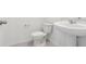 A well-lit, all white bathroom features a pedestal sink, and toilet with sleek, modern fixtures at 4337 Switchgrass Ln, St Cloud, FL 34772