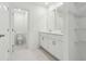 Bathroom with double sinks, white cabinets, toilet, and tile flooring at 4337 Switchgrass Ln, St Cloud, FL 34772