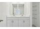 Bathroom with double sinks and a shared mirror and wire rack shelving at 4337 Switchgrass Ln, St Cloud, FL 34772