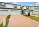 Newly built townhomes feature brick driveways, attached garages, and beautifully manicured front yards at 4337 Switchgrass Ln, St Cloud, FL 34772