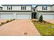 Charming two-story townhome with a brick driveway and a well-maintained front yard at 4337 Switchgrass Ln, St Cloud, FL 34772