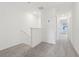Bright upstairs hallway with neutral carpet leading to bedrooms and other living spaces at 4337 Switchgrass Ln, St Cloud, FL 34772