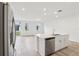 Modern kitchen boasts an island, stainless steel appliances, and a view to the light-filled living space at 4337 Switchgrass Ln, St Cloud, FL 34772