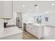 Bright, modern kitchen features stainless steel appliances, an island with seating, and light wood flooring at 4337 Switchgrass Ln, St Cloud, FL 34772