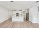 Bright, open-concept living space featuring a kitchen island and wood-look flooring at 4337 Switchgrass Ln, St Cloud, FL 34772