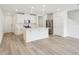 Bright, open-concept living space featuring a kitchen island and stainless steel appliances at 4337 Switchgrass Ln, St Cloud, FL 34772