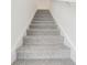 Carpeted staircase leading upwards, showcasing a clean and bright transition between floors at 4337 Switchgrass Ln, St Cloud, FL 34772
