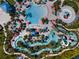 Aerial view of community pool with ample seating, water features and mature landscaping at 4361 Lana Ave, Davenport, FL 33897