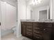 Bathroom with a double vanity, granite countertop, and a shower and toilet area at 4361 Lana Ave, Davenport, FL 33897
