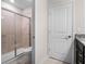 Bathroom including a tiled shower with glass door and a separate toilet room at 4361 Lana Ave, Davenport, FL 33897