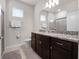 Bathroom includes granite countertops, dark wood cabinets, a toilet, and shower, optimizing functionality and style at 4361 Lana Ave, Davenport, FL 33897