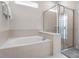 Bathroom showcasing a soaking tub and glass-enclosed shower, designed for relaxation and modern living at 4361 Lana Ave, Davenport, FL 33897