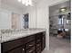 Bathroom vanity with granite countertop, dark cabinets, and a view of the adjacent themed bedroom at 4361 Lana Ave, Davenport, FL 33897