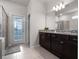 Bathroom boasts granite counters, dark wood cabinets, and a glass shower, creating a luxurious and functional space at 4361 Lana Ave, Davenport, FL 33897