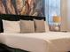 Bedroom with modern design, botanical wallpaper, a plush headboard, and luxurious bedding for ultimate comfort at 4361 Lana Ave, Davenport, FL 33897