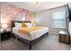 Bedroom with a statement wall, plush bedding, and soft lighting, creating a warm and inviting retreat at 4361 Lana Ave, Davenport, FL 33897