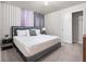 Modern bedroom featuring a queen-sized bed, stylish accent wall, and natural lighting at 4361 Lana Ave, Davenport, FL 33897