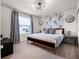 Bedroom features a modern light fixture, stylish wallpaper, and neutral decor, creating a serene and inviting space at 4361 Lana Ave, Davenport, FL 33897