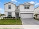 Beautiful two-story home with a manicured lawn and a gray brick driveway at 4361 Lana Ave, Davenport, FL 33897