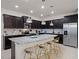 Gourmet kitchen with dark wood cabinets, granite countertops, and stainless steel appliances at 4361 Lana Ave, Davenport, FL 33897