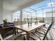 Covered patio with dining table, chairs, and lounge furniture, perfect for outdoor entertaining, with a view of the pool at 4361 Lana Ave, Davenport, FL 33897